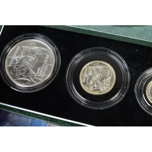 154 - A CARDBOARD BOX CONTAINING UK ROYAL MINT COIN PROOF SETS to include two three cased one pound silver... 