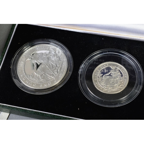 154 - A CARDBOARD BOX CONTAINING UK ROYAL MINT COIN PROOF SETS to include two three cased one pound silver... 