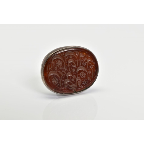 2 - AN ANTIQUE MIDDLE EASTERN SEAL, the oval orange panel assessed as paste, carved with floral decorati... 