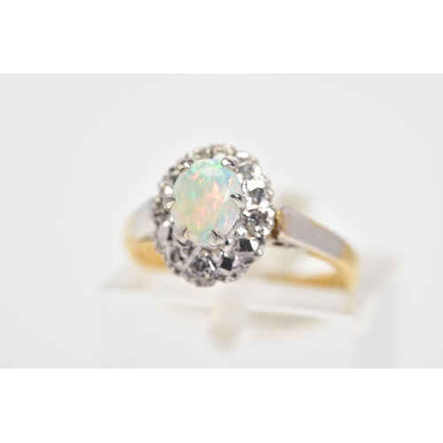 23 - AN 18CT GOLD OPAL AND DIAMOND CLUSTER RING, the central oval opal cabochon within a surround set wit... 