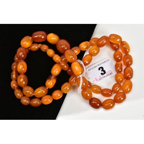 3 - A NATURAL AMBER BEAD NECKLACE, fifty fine oval beads graduating in size from 9mm x 5.5mm to 16mm x 1... 