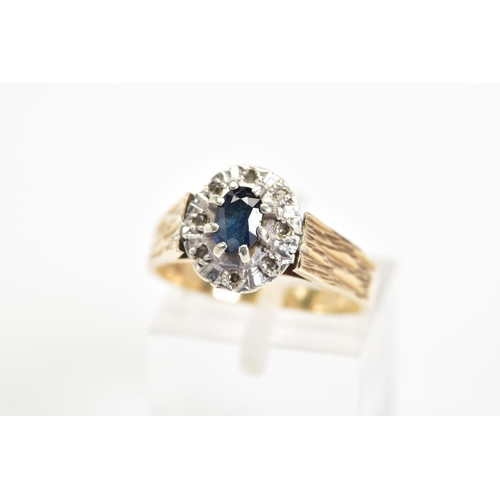 30 - A 9CT GOLD SAPPHIRE AND DIAMOND CLUSTER RING, the central oval sapphire within a surround of eight s... 