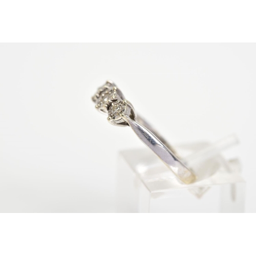 31 - A 9CT WHITE GOLD THREE STONE DIAMOND RING, designed as three brilliant cut diamonds within illusion ... 