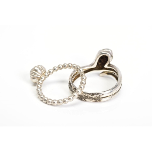 32 - A PANDORA RING AND A SNAKE RING, the Pandora ring designed with a circular rock crystal cabochon wit... 