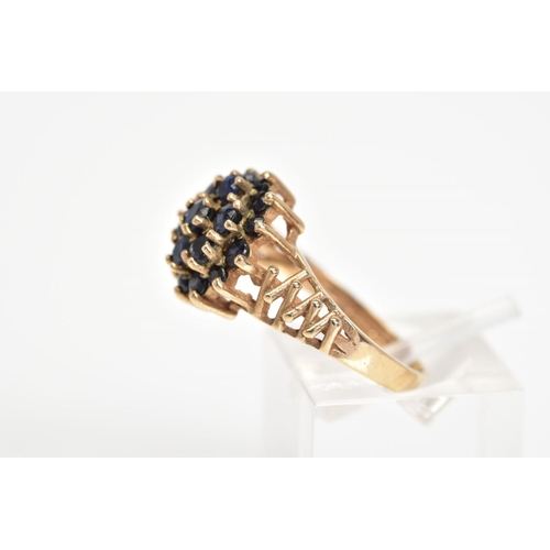 37 - A 9CT GOLD SAPPHIRE CLUSTER RING, designed as a tiered cluster of claw set circular sapphires to the... 