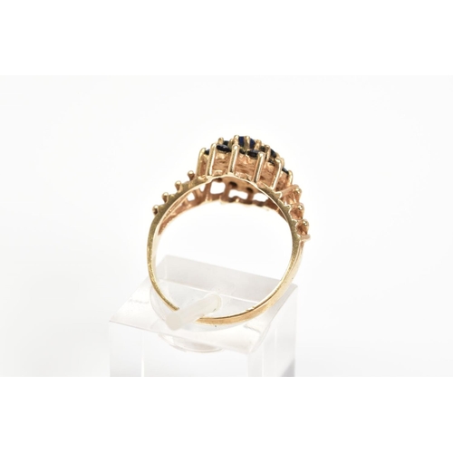 37 - A 9CT GOLD SAPPHIRE CLUSTER RING, designed as a tiered cluster of claw set circular sapphires to the... 