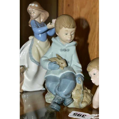 395 - THREE NAO FIGURES, comprising Ballerina, pensive, length 22.5cm, a boy sitting with rabbit and satch... 