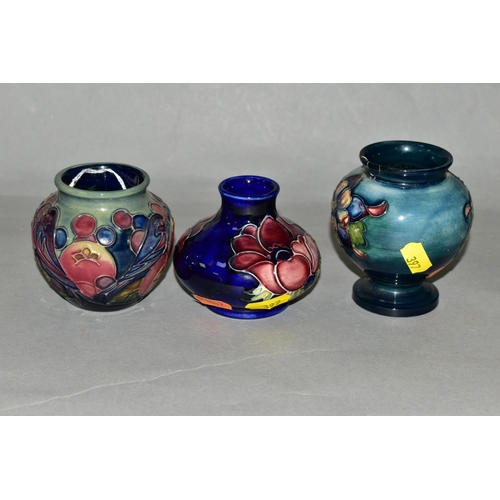 397 - THREE SMALL MOORCROFT POTTERY VASES, 'Finches and Fruit' pattern, height 7.5cm, 'Anemone' pattern on... 