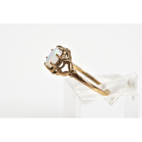 40 - A 9CT GOLD OPAL RING, designed as an oval cabochon opal within an eight claw scalloped surround to t... 