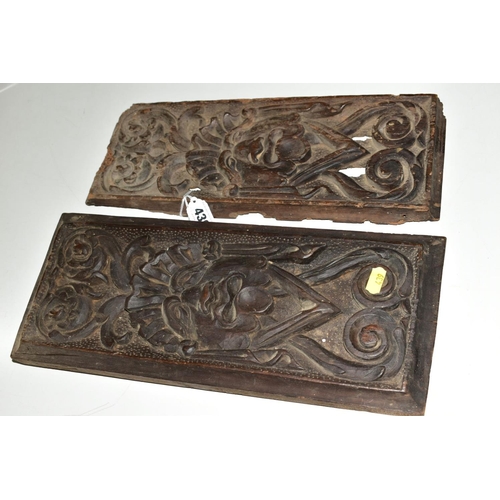 439 - TWO CARVED TREEN PANELS, of rectangular form, 17th Century and later, carved with identical mask and... 