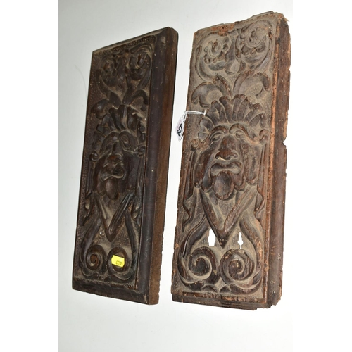 439 - TWO CARVED TREEN PANELS, of rectangular form, 17th Century and later, carved with identical mask and... 