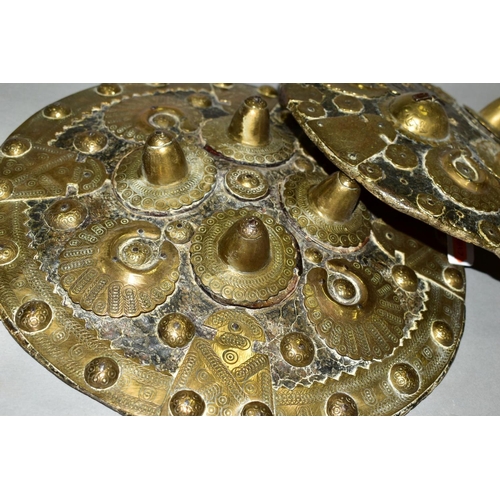 488 - TWO INDIAN/PERSIAN LEATHER AND BRASS MOUNTED SHIELDS, losses to the front of the smaller shield, bot... 