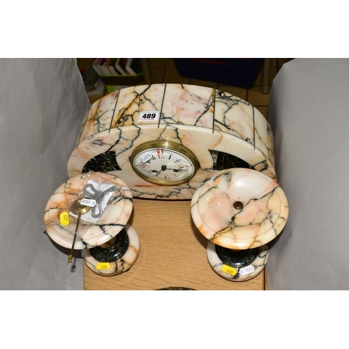 489 - AN EARLY 20TH CENTURY VEINED MARBLE CLOCK GARNITURE, the domed clock with enamel dial, lozenge shape... 