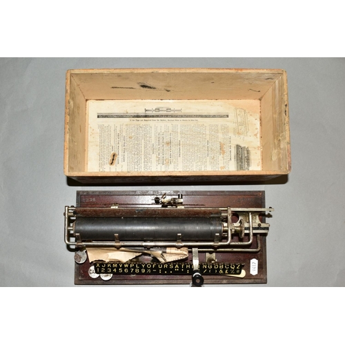 498 - A CASED MERRITT TYPEWRITER, Amercian circa late 19th century, mounted on a wooden base stamped '1234... 