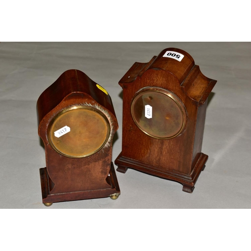 500 - TWO EDWARDIAN MAHOGANY MANTEL CLOCKS, both with wavy domes and white enamel dials, one with inlaid c... 