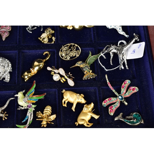 57 - A SELECTION OF COSTUME JEWELLERY BROOCHES, to include various animal designs, an elephant set with c... 