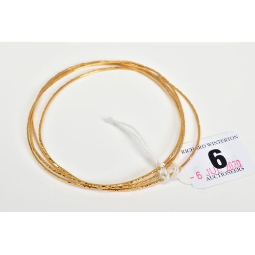 6 - FOUR 18CT GOLD BANGLES, comprising a set of thin bangles with engraved detail, all with 18ct import ... 