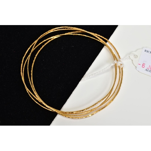 6 - FOUR 18CT GOLD BANGLES, comprising a set of thin bangles with engraved detail, all with 18ct import ... 