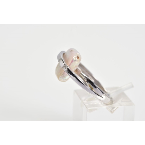 81 - A 9CT WHITE GOLD RING, designed as a square mother of pearl centre with a vertical crossover bar set... 