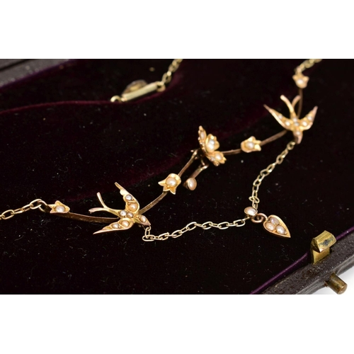 1 - A GOLD EDWARDIAN SPLIT PEARL NECKLACE, formed of swallows and floral detail between blade bar sectio... 