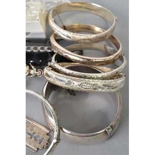 120 - A SELECTION OF ITEMS, to include six silver engraved bangles, a silver curb link charm bracelet, wit... 