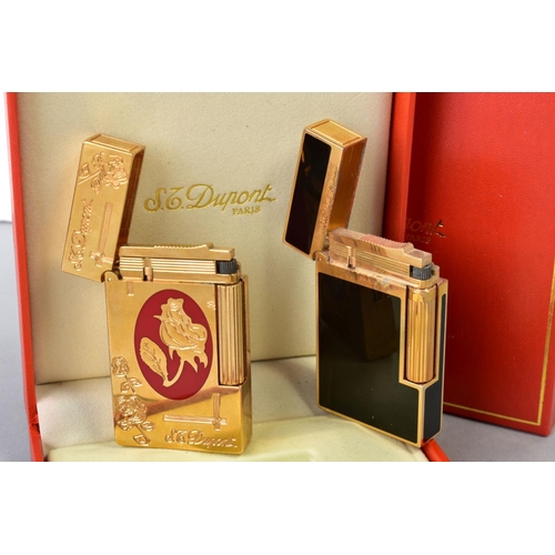 130 - TWO S T DUPONT OF PARIS LIGHTERS, the first a rectangular design of black enamel and gold plate, wit... 