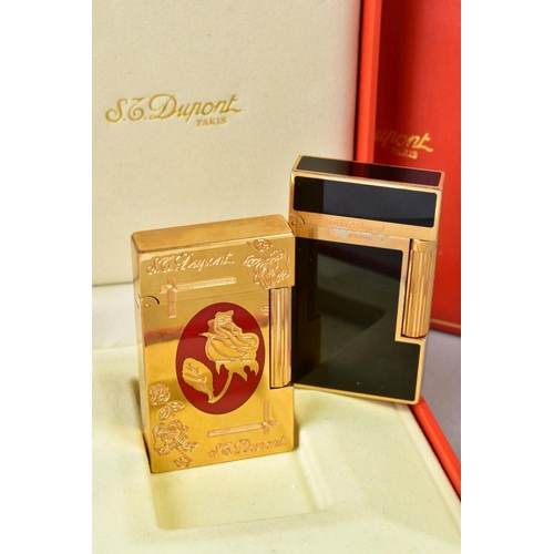 130 - TWO S T DUPONT OF PARIS LIGHTERS, the first a rectangular design of black enamel and gold plate, wit... 