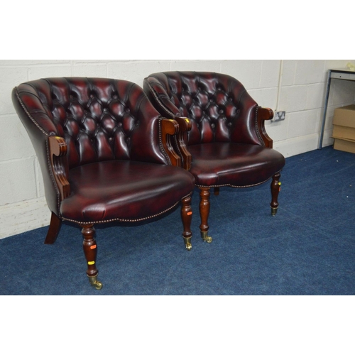 1308 - A PAIR OF MODERN OXBLOOD LEATHER BUTTON BACK ARMCHAIRS on brassed casters, width 67cm x depth 71cm x... 