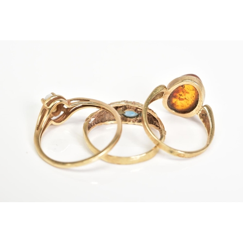 143 - THREE GEM SET RINGS, the first ring designed with an oval cabochon amber, with detailed shoulders, w... 