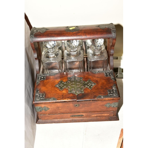 222 - AN OAK CASED TANTALUS WITH COMPARTMENT AND DRAWER TO THE FRONT, bound with brass fittings, approxima... 