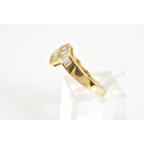 23 - AN 18CT GOLD DIAMOND RING, of crossover design set with ten baguette/tapered baguette cut diamonds t... 