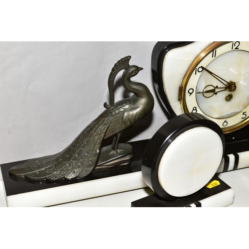 230 - A FRENCH ART DECO BLACK AND WHITE CLOCK GARNITURE, the dial has Arabic numerals and pierced gilt han... 