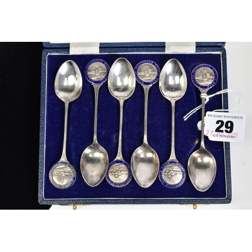 29 - A SET OF SIX SILVER TEASPOONS, each with a round blue enamel medal depicting a rifle men, to each ha... 