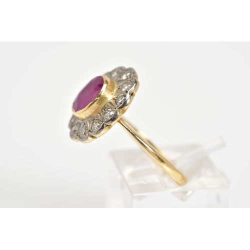 39 - AN 18CT GOLD CLUSTER RING, set with a central oval ruby with a round brilliant cut diamond surround,... 