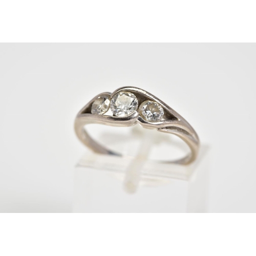 44 - AN 18CT WHITE GOLD DIAMOND RING, set with three round brilliant cut diamonds in an open work cross o... 