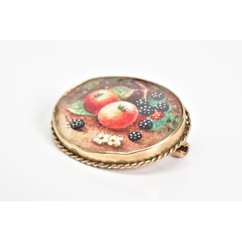 49 - A BROOCH, of oval design featuring a fruit painting within a collet mount and rope twist surround, s... 