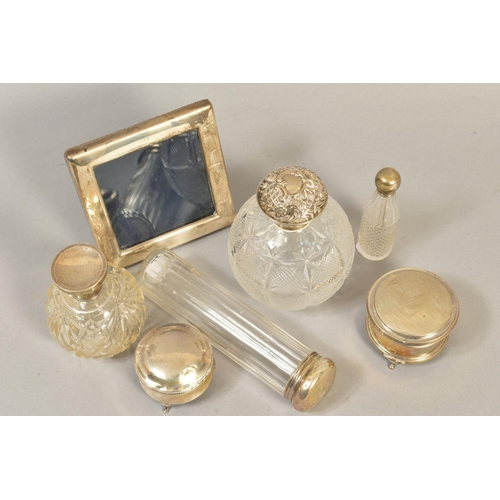 103 - A GROUP OF DRESSING TABLE SILVER, including two spherical cut glass scent bottles with silver pull o... 