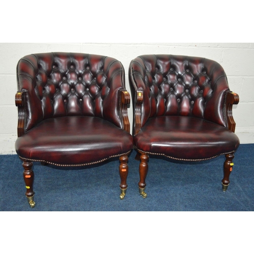 1308 - A PAIR OF MODERN OXBLOOD LEATHER BUTTON BACK ARMCHAIRS on brassed casters, width 67cm x depth 71cm x... 