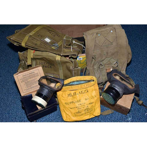 164 - A BOX CONTAINING MILITARY KIT/SURVIVAL BAGS BRITISH/US, together with two British issue WWII style/e... 