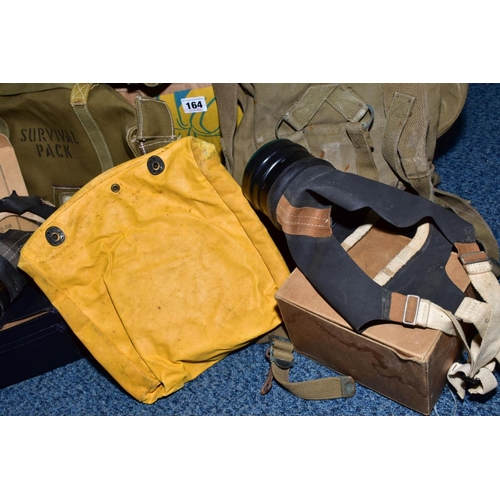 164 - A BOX CONTAINING MILITARY KIT/SURVIVAL BAGS BRITISH/US, together with two British issue WWII style/e... 