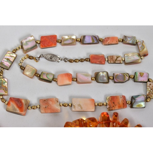 21 - A SELECTION OF NECKLACES, to include two modern amber bead necklaces, lengths 520mm - 670mm, a pink ... 