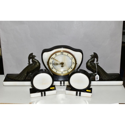 230 - A FRENCH ART DECO BLACK AND WHITE CLOCK GARNITURE, the dial has Arabic numerals and pierced gilt han... 