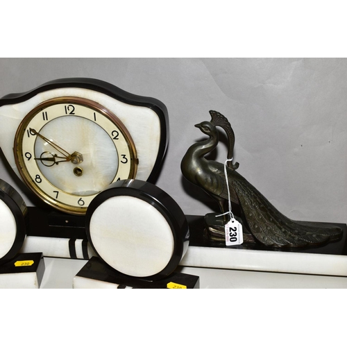 230 - A FRENCH ART DECO BLACK AND WHITE CLOCK GARNITURE, the dial has Arabic numerals and pierced gilt han... 