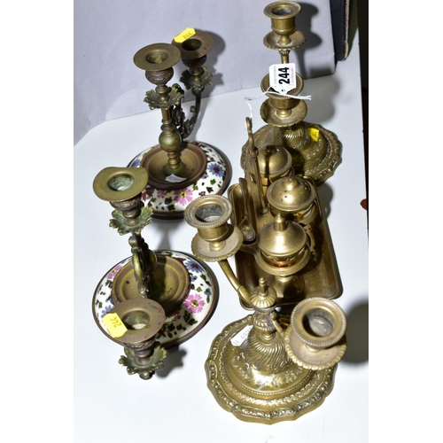 244 - A PAIR OF CHAMPLEVE STYLE WEIGHTED FRENCH PIANO SCONCES, together with a pair of brass candlesticks ... 