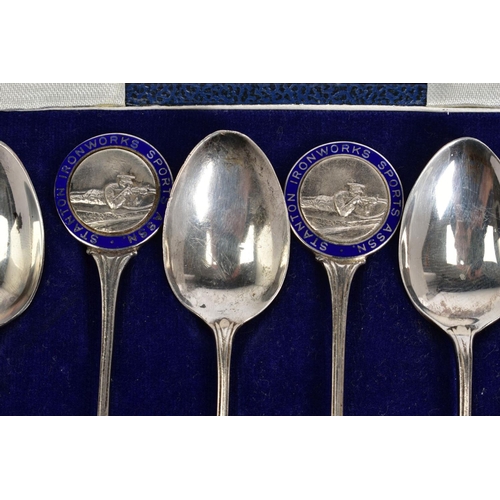 29 - A SET OF SIX SILVER TEASPOONS, each with a round blue enamel medal depicting a rifle men, to each ha... 