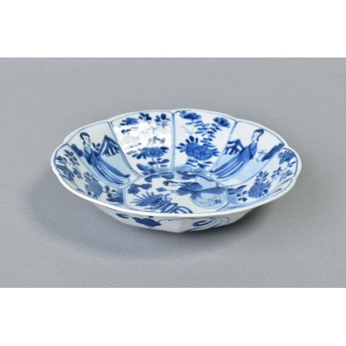 62 - A CHINESE KANGXI BLUE AND WHITE PORCELAIN BOWL, of ten petal outline, decorated with female attendan... 