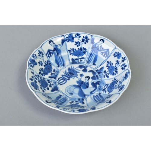 62 - A CHINESE KANGXI BLUE AND WHITE PORCELAIN BOWL, of ten petal outline, decorated with female attendan... 