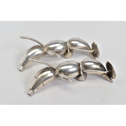 65 - A PAIR OF EARLY 20TH CENTURY CHINESE SILVER PEPPERETTES, in the form of bean or seed pods, each with... 