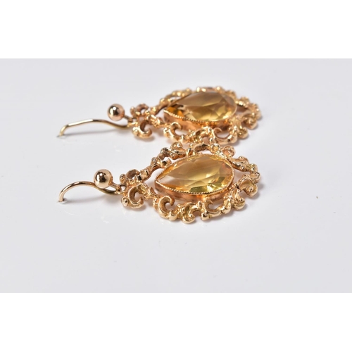 73 - A PAIR OF DROP EARRINGS, each designed with a pear cut citrine within a filigree surround, to the fi... 