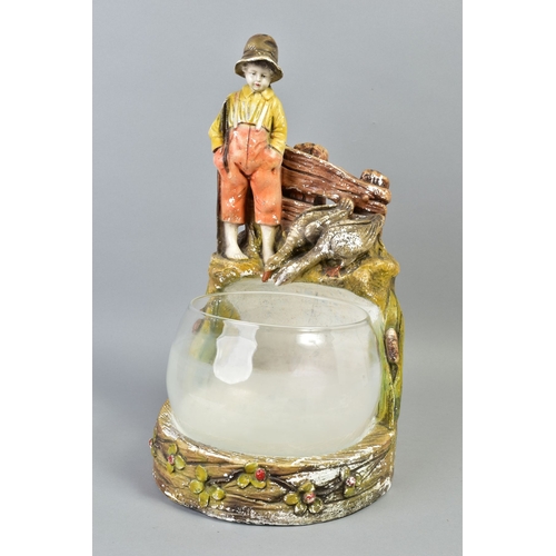 222A - A 1920'S/30'S GLASS FISH BOWL ON FIGURAL PLASTER STAND, modelled as a bare footed young boy with fis... 